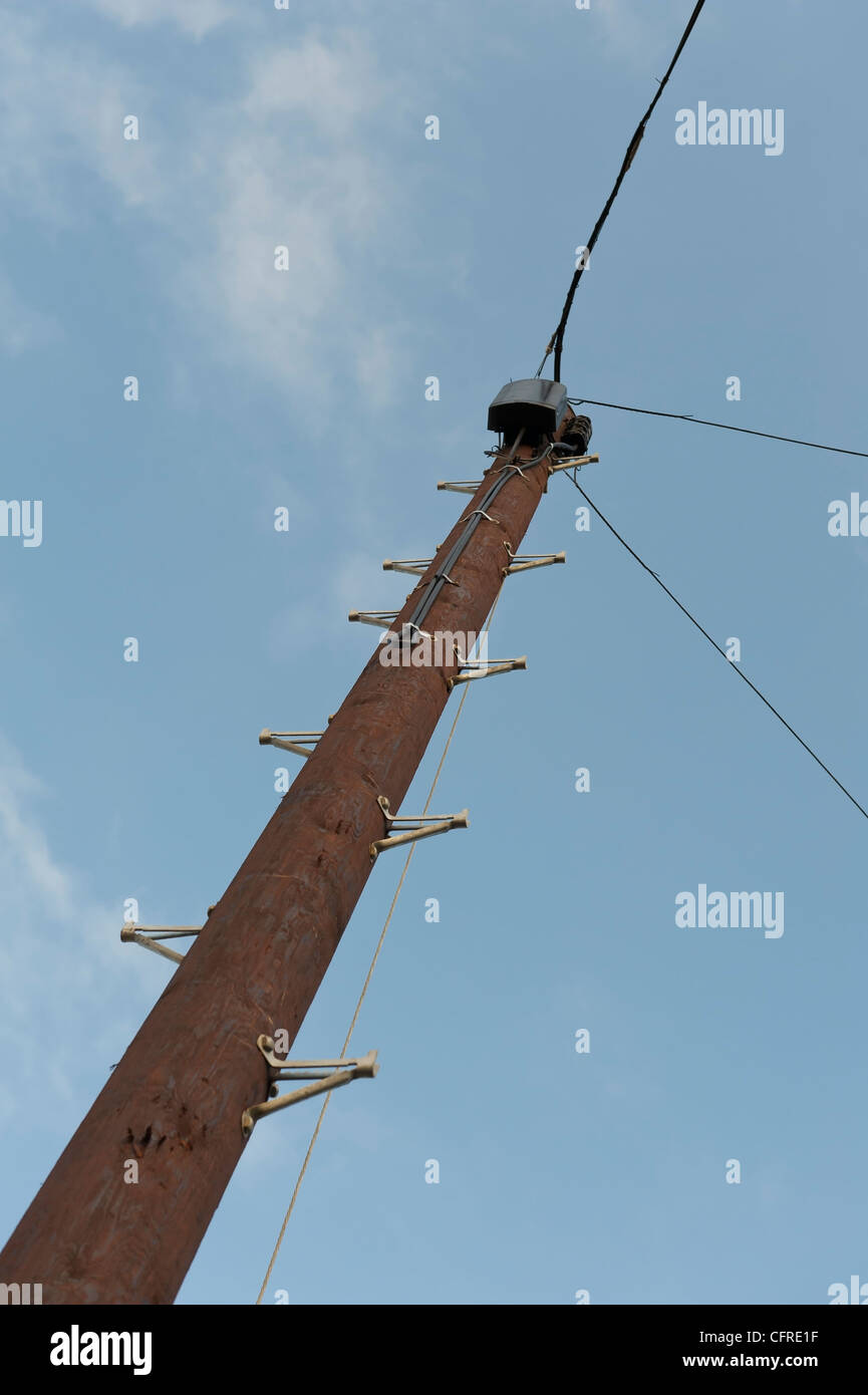 A new wooden telegraph pole with telephone lines connected. Stock Photo