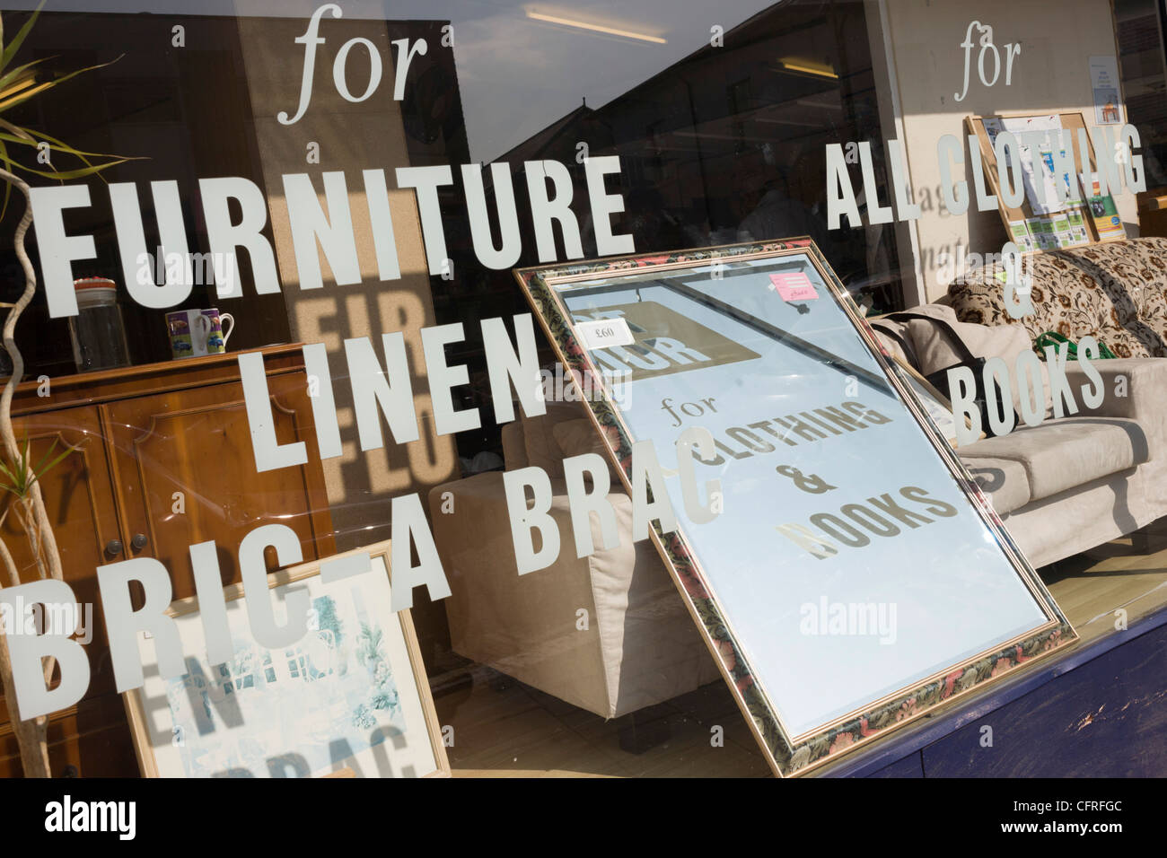 Reflections Of Lettering And Writing On A Charity Shop Window Selling Stock Photo Alamy