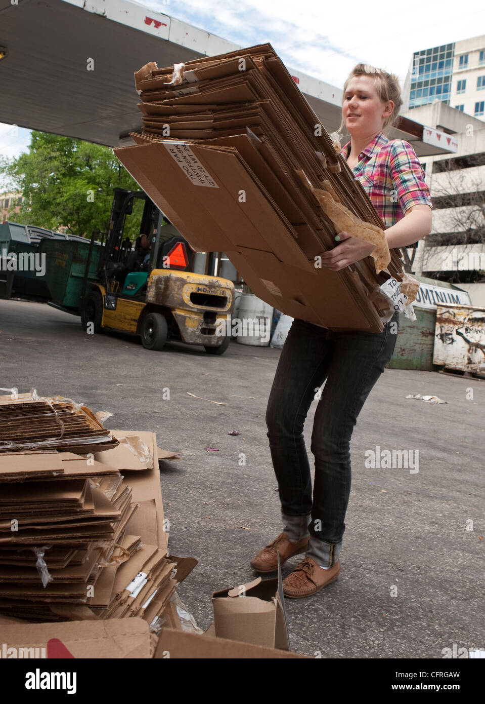 Young citizens bring in cardboard to a recycling dropoff and