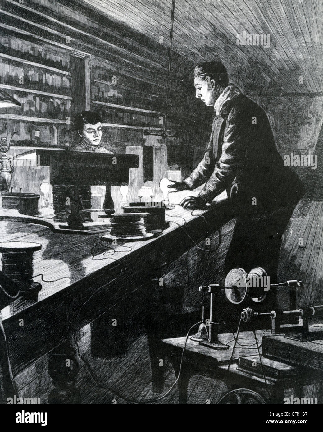 THOMAS EDISON (1847-1931) and assistant experimenting with electric lights Stock Photo