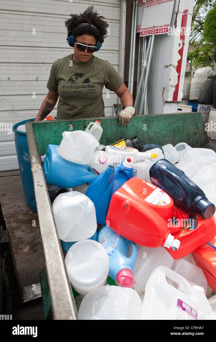 Workers sort through plastics at a recycling dropoff and processing