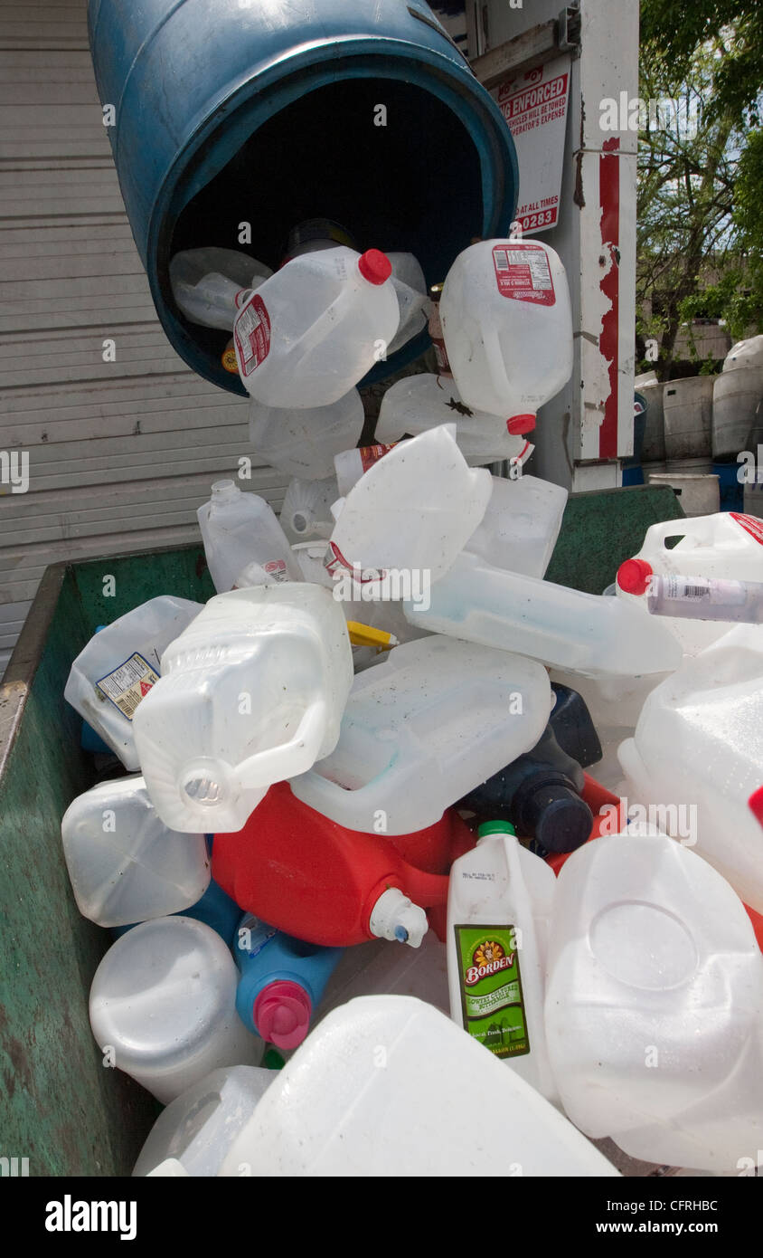 Workers sort through plastics at a recycling dropoff and processing