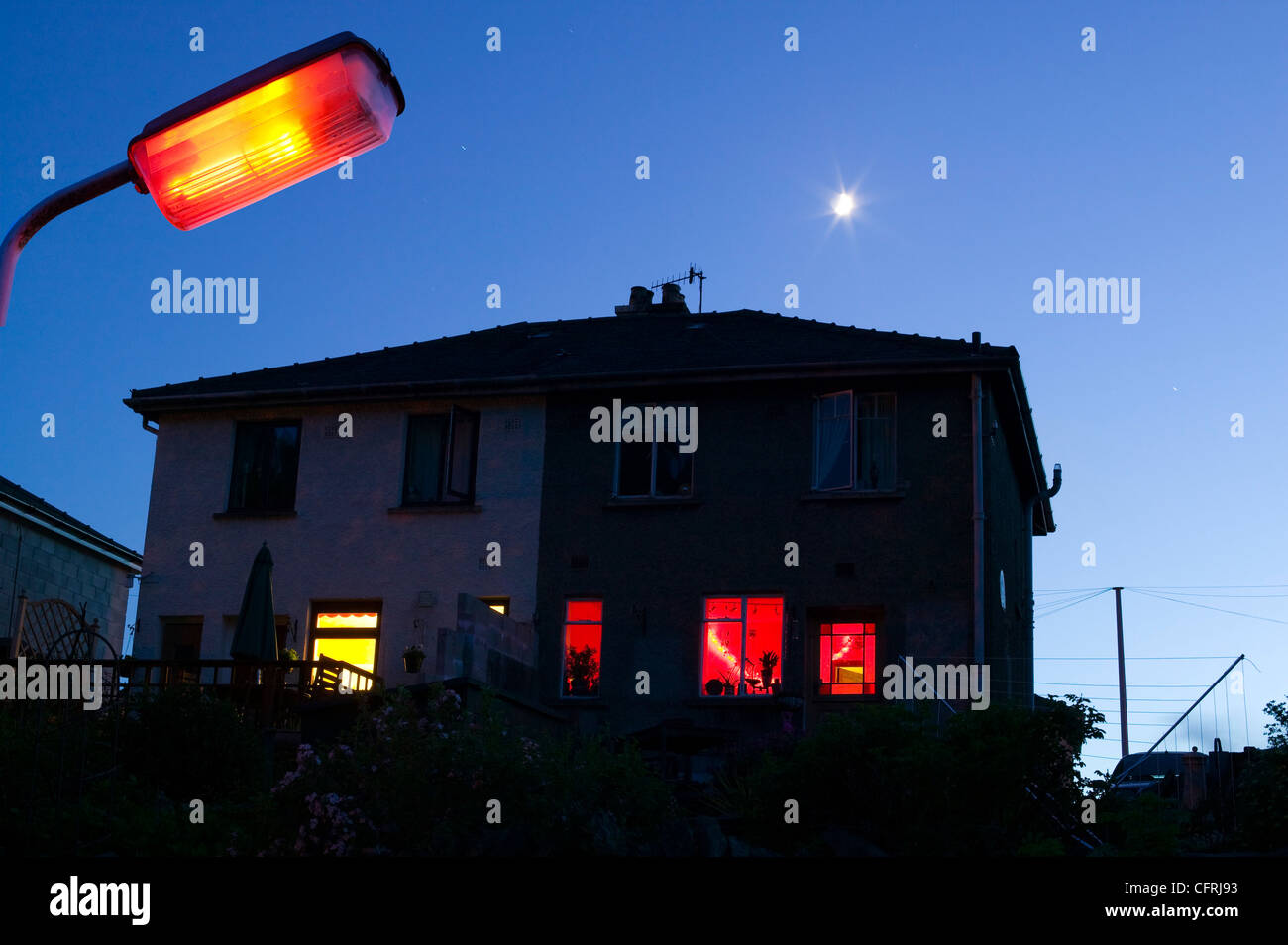 A house at night with a moon in Ambleside UK Stock Photo