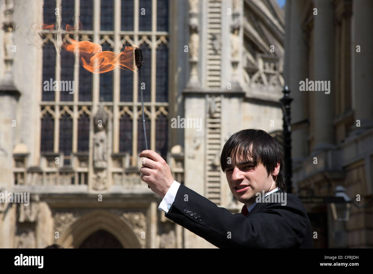 Street entertainter as fire eater outside Bath Abbey in Bath, Somerset Stock Photo