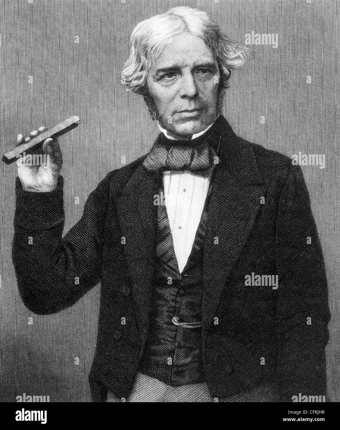 MICHAEL FARADAY (1791-1867) English scientist holding a bar magnet Stock Photo