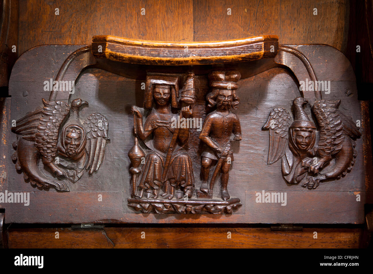 UK, England, Worcestershire, Worcester Cathedral Quire, medieval misericord showing woman, with distaff and man digging Stock Photo