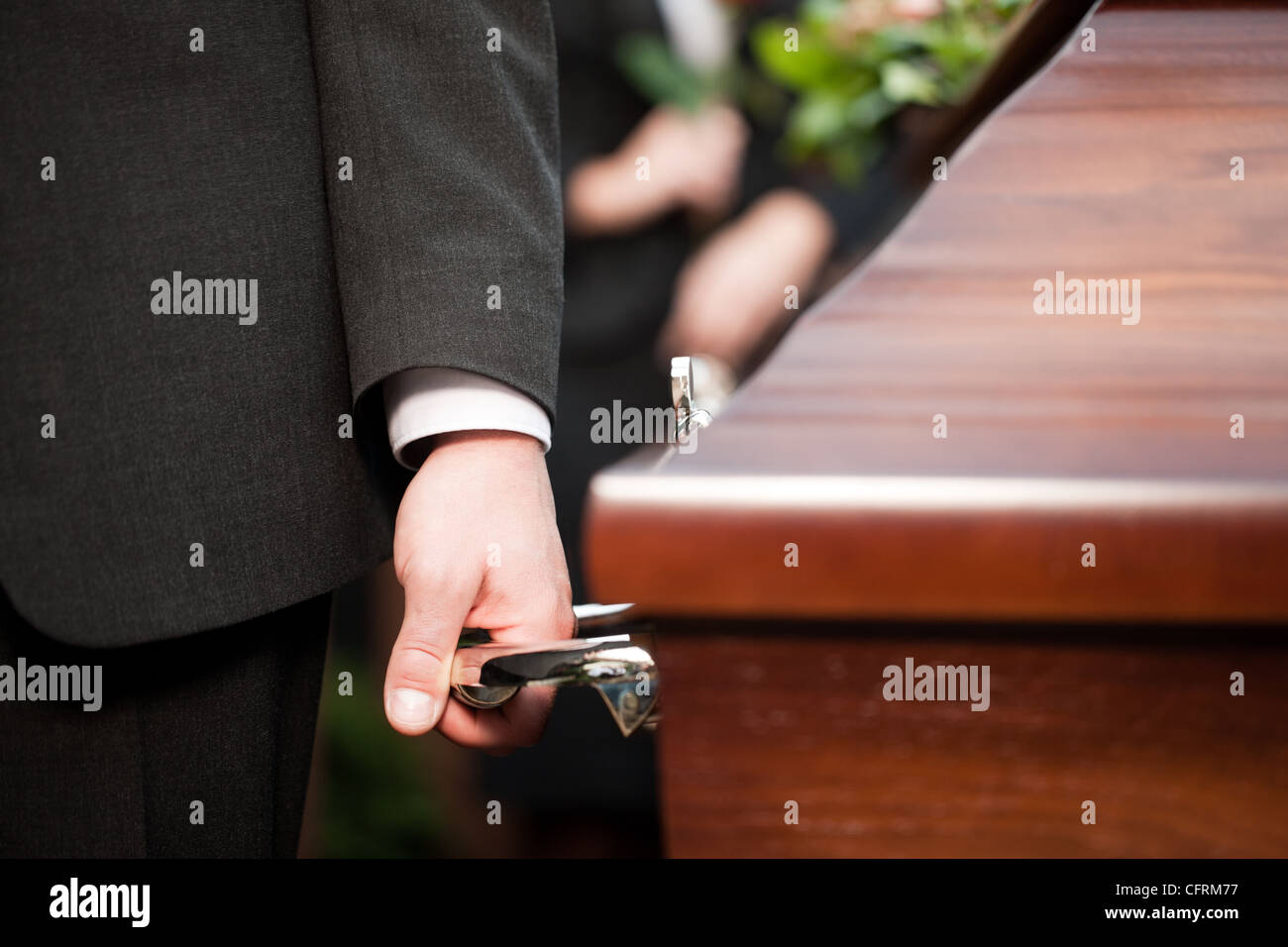 Religion, death and dolor - coffin bearer carrying casket at funeral to cemetery Stock Photo