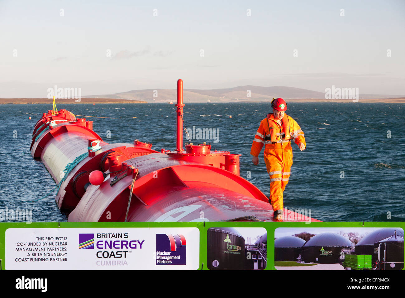 A Pelamis P2 wave energy generator on the dockside at Lyness on Hoy, Orkney Isles, Scotland, UK. Stock Photo