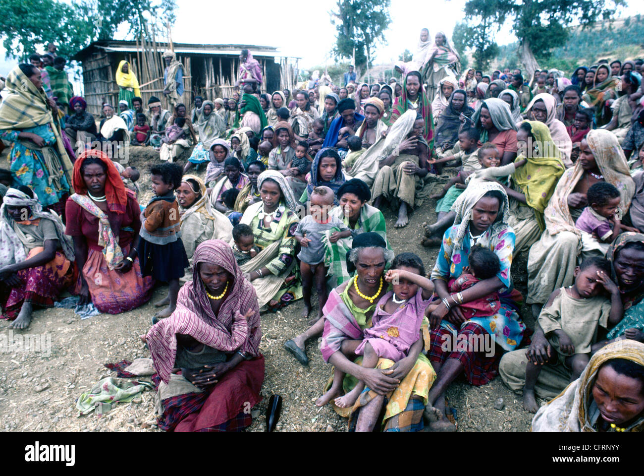 MORE THAN A HUNDRED ETHIOPAIN  WOMEN WITH CHILDREN WAIT AT A FOOD DISTRIBUTION LOCATION Stock Photo