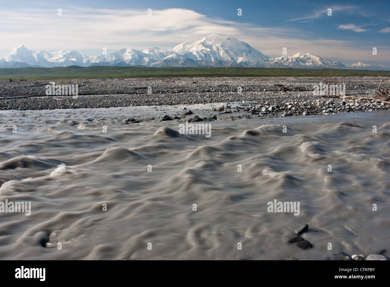 The glacial silt laden water of the McKinley River flows in front of Denali (Mt. McKinley) in Denali National Park, AK, USA. Stock Photo