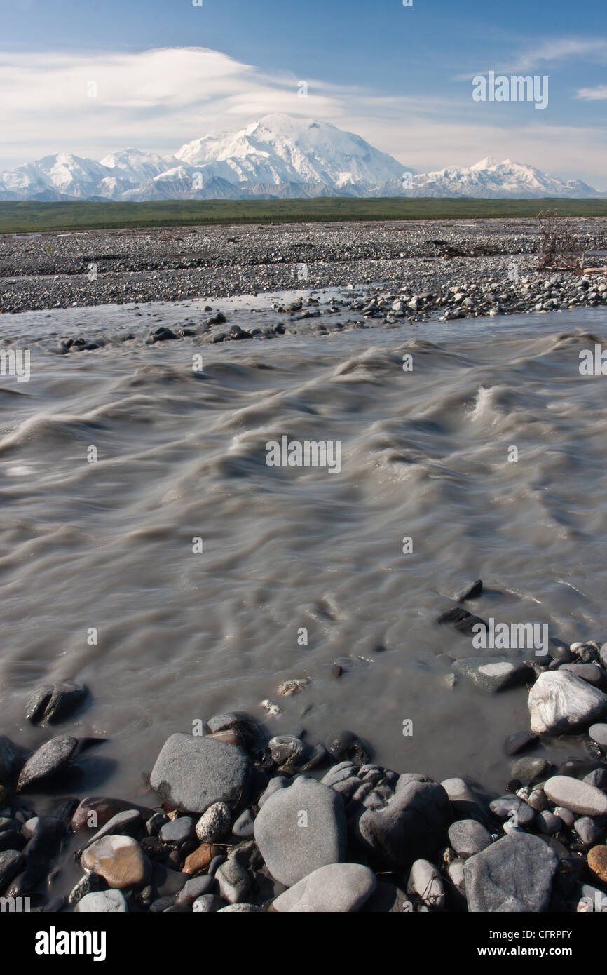 The glacial silt laden water of the McKinley River flows in front of Denali (Mt. McKinley) in Denali National Park, AK, USA. Stock Photo
