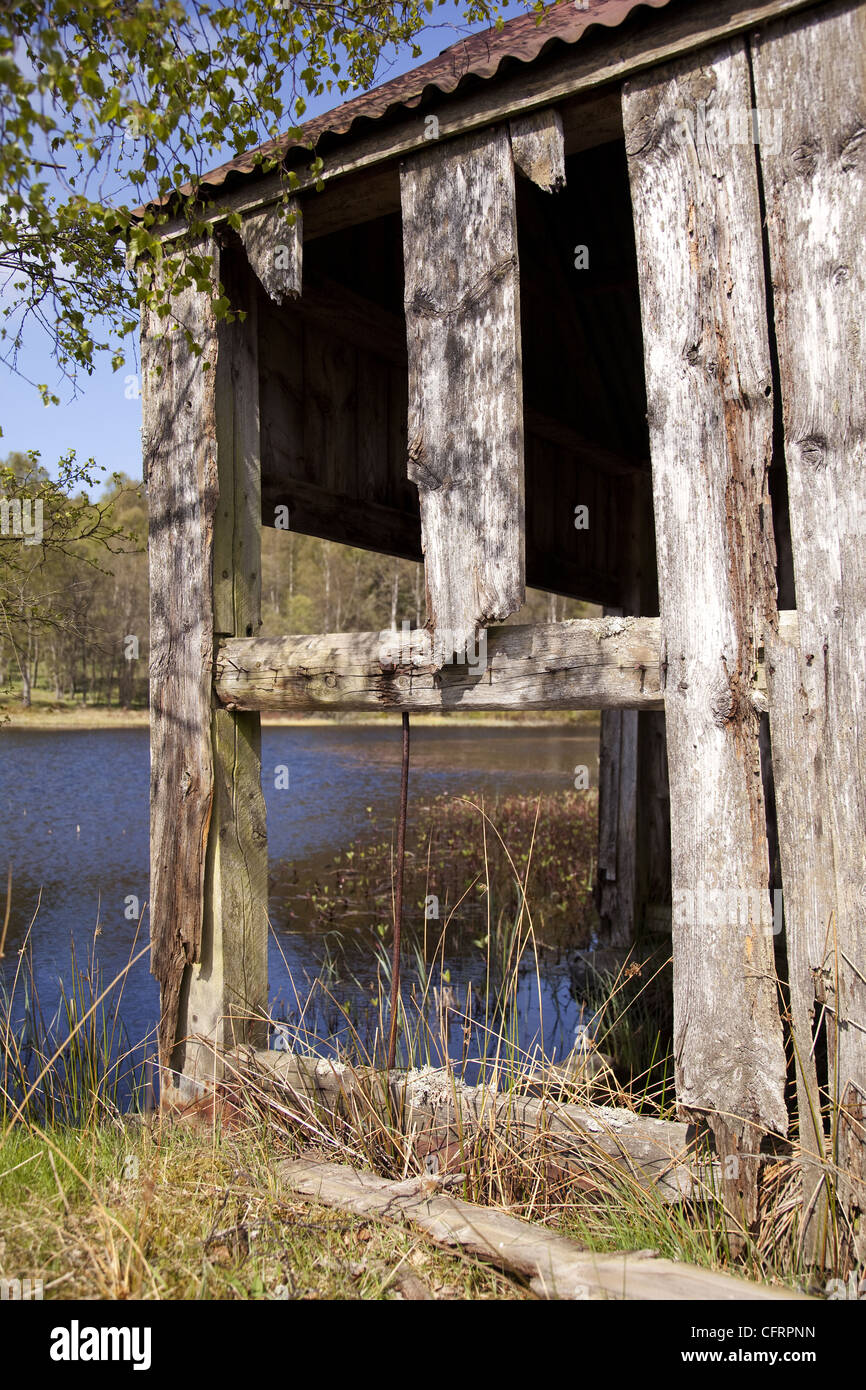 Rotting boatshed at the side of a loch in Scotland Stock Photo