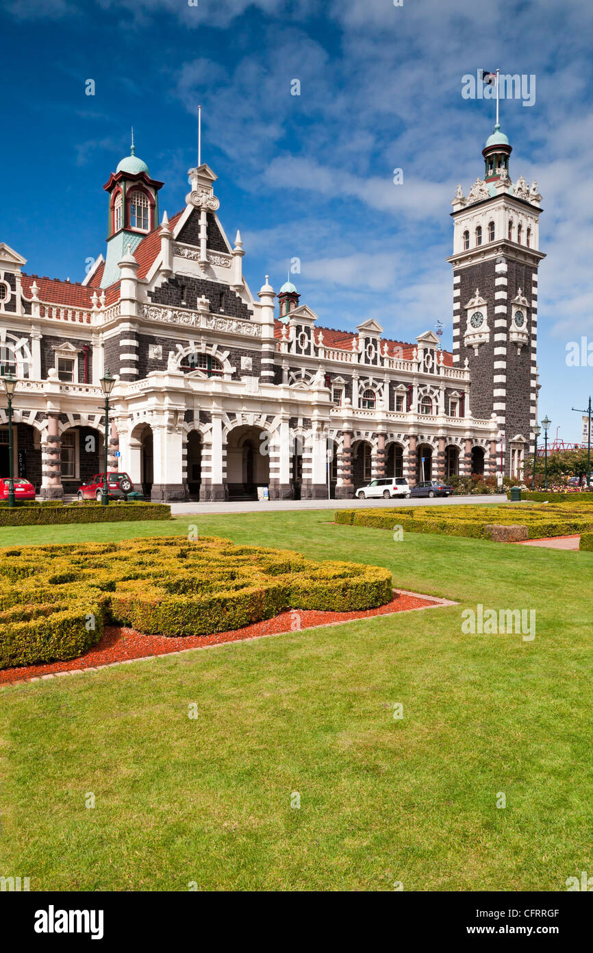 Dunedin Railway Station, now only used by the Taieri Gorge preservation railway, seen across the gardens in Anzac Square. Stock Photo