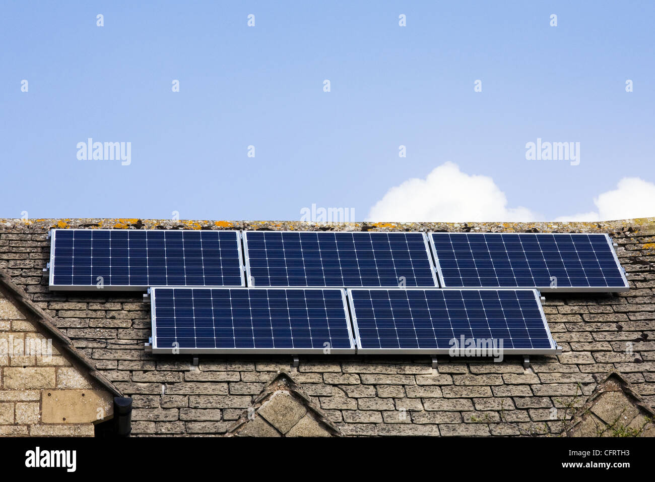 Solar panels on a Cotswold stone house. Stock Photo