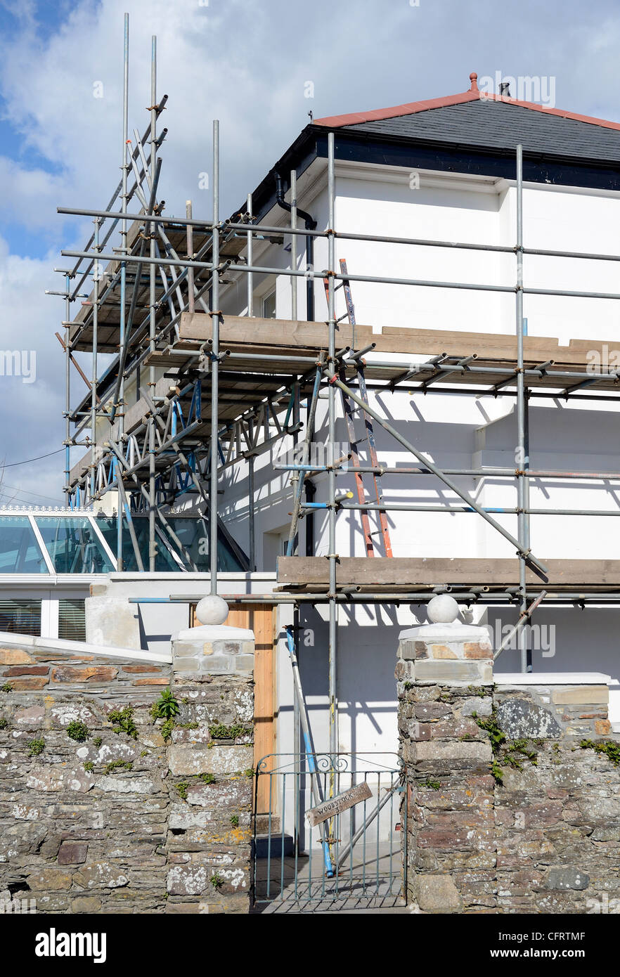 Scaffolding around a house undergoing some repairs Stock Photo
