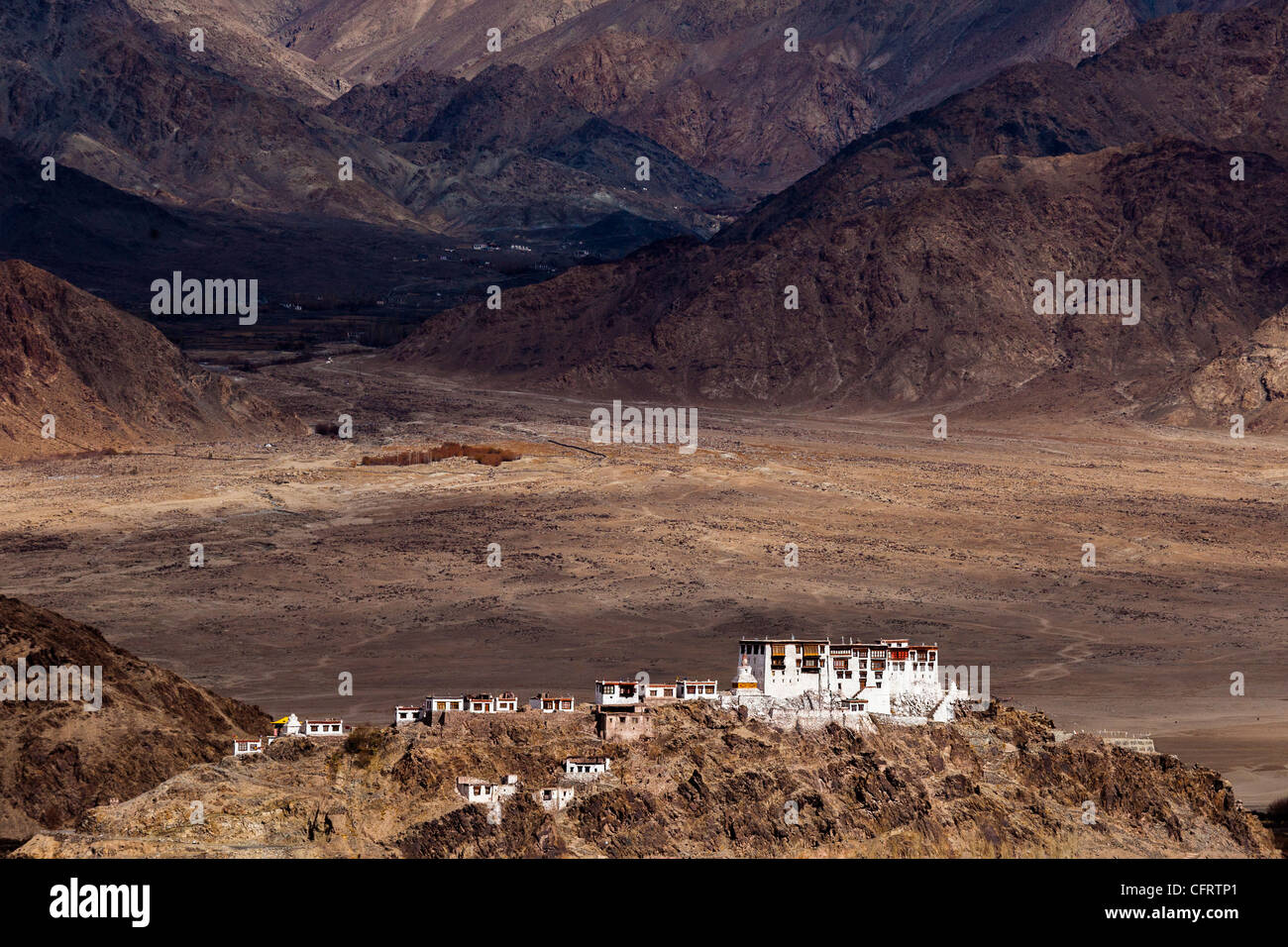 The Stakna monastery perched upon a small hill with the mountains of the Ladakh range looming in the background. Stock Photo
