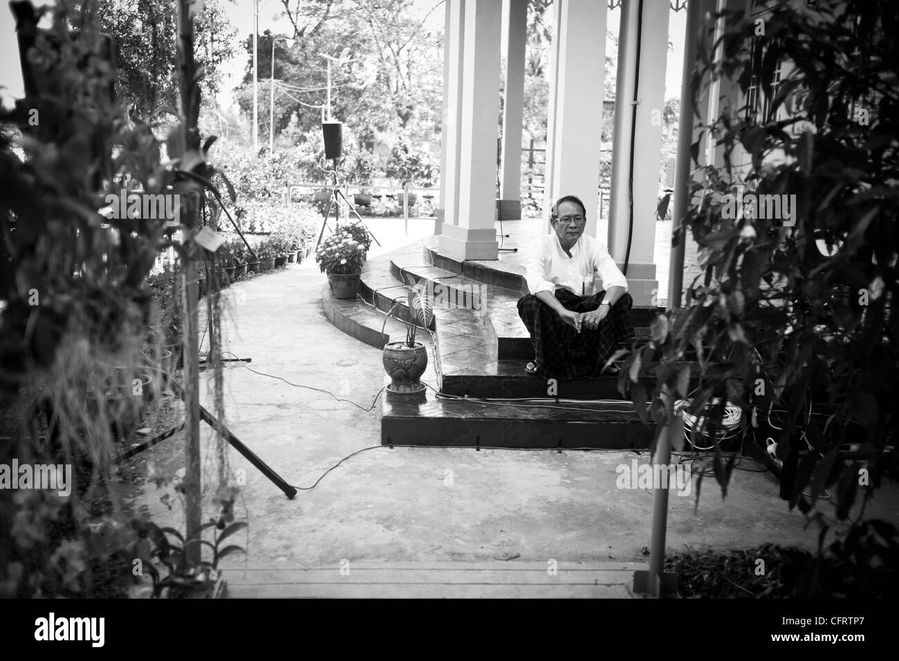 Aung San Suu Kyi's personal assistants take time out from the usual busy day and rest in the garden of her home in Rangoon Stock Photo