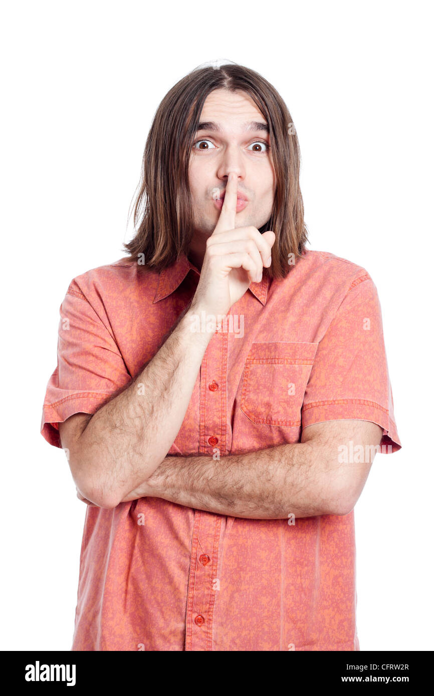 Young longhaired man gesturing silence, isolated on white background. Stock Photo