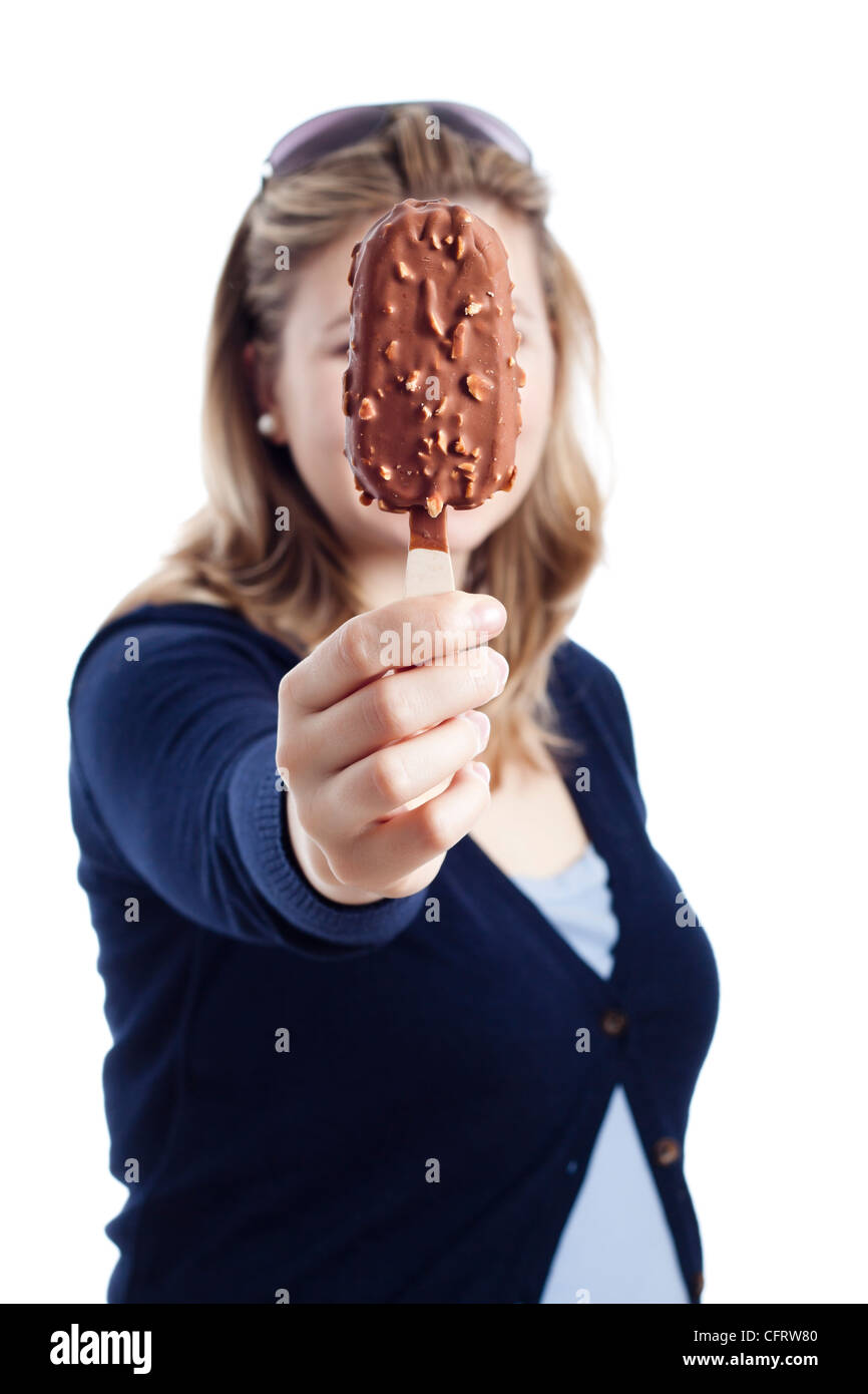 Young woman holding chocolate popsicle, isolated on white background. Stock Photo