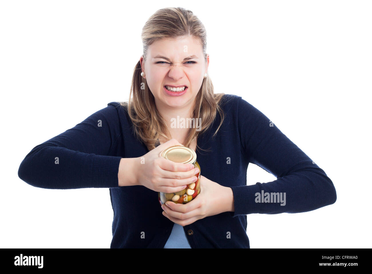 Young woman struggling to open bottle, isolated on white background. Stock Photo