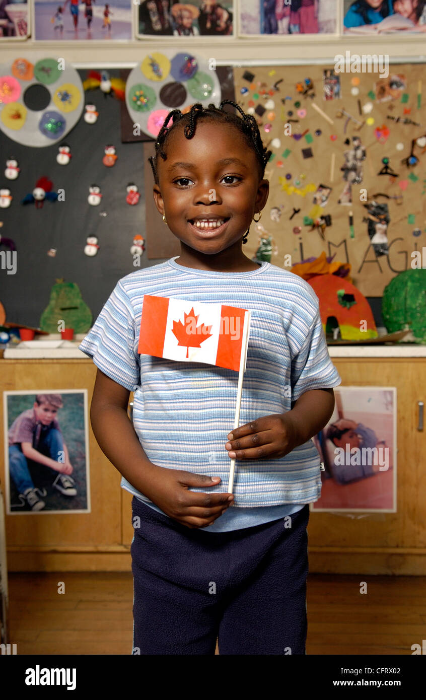 Five Year Old Girl with Canadian Flag in a Classroom Stock Photo