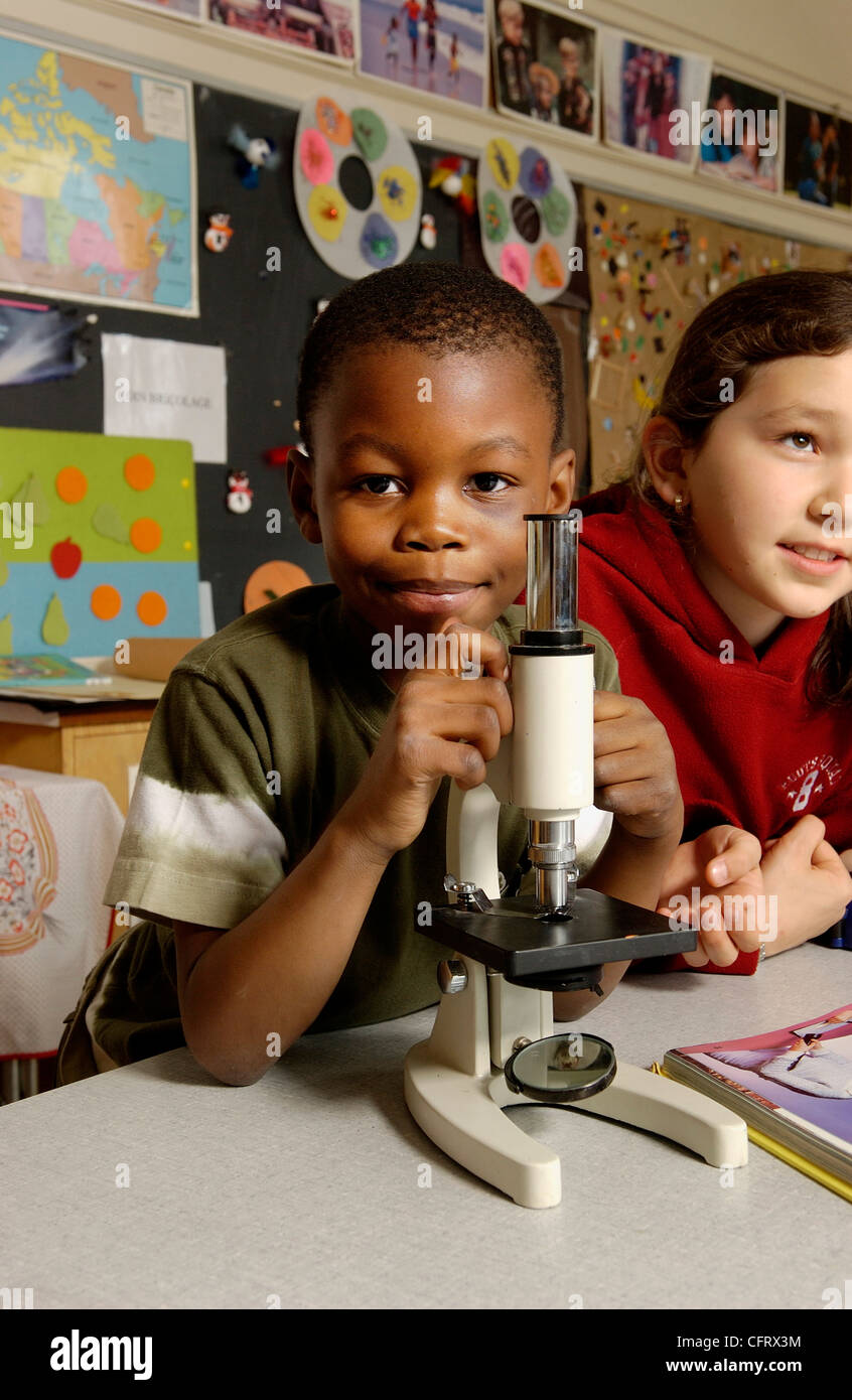 Young Boy with Microscope in a Classroom Stock Photo Alamy
