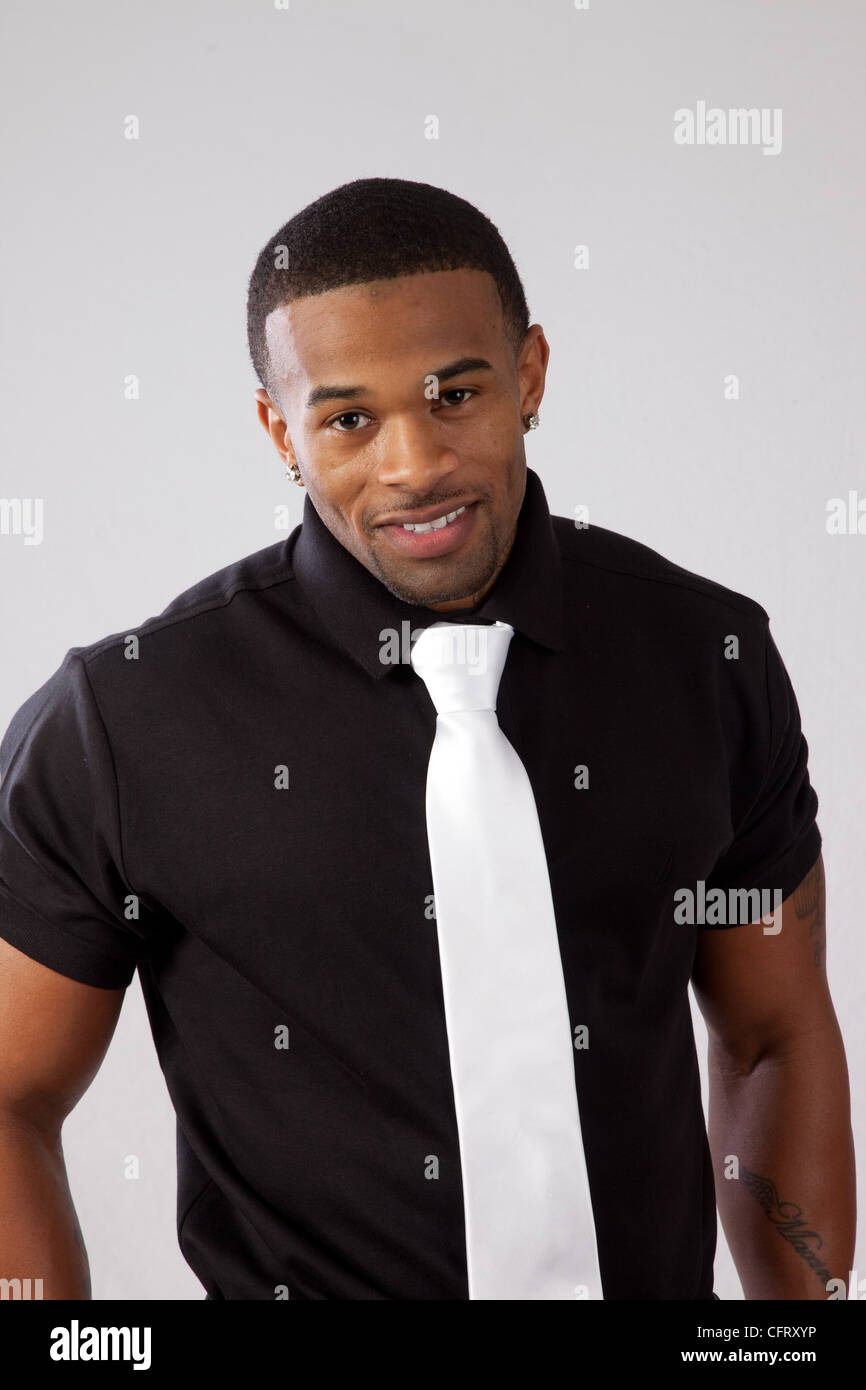Handsome black man, with a white tie looking   at the camera  with a big smile Stock Photo