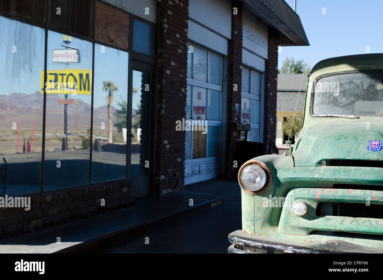 Rt 66, Ludlow, CA gas station, oxidized green truck with motel reflection Stock Photo