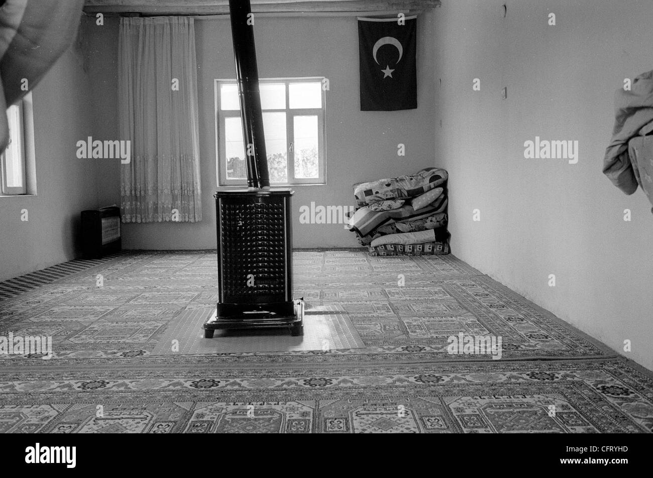 A coal heater dominates a room in a simple house in a tiny Kurdish