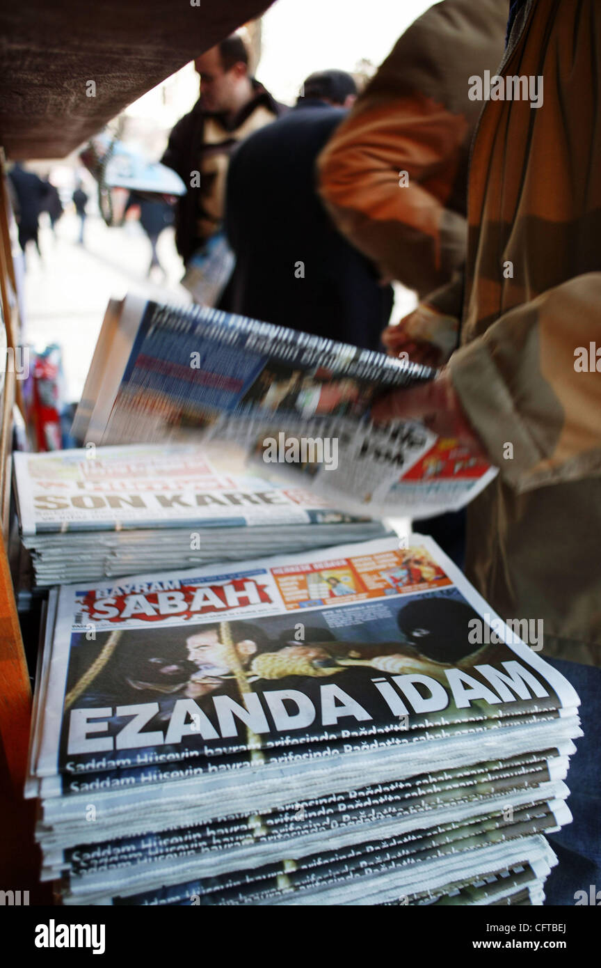 The front page of Turkey's Sabah newspaper at a newsstand in Istanbul December 31 2006. The headline reads in Turkish 'Executed during the call to prayer' and shows Saddam Hussein before his hanging yesterday in Baghdad for crimes against humanity. Stock Photo