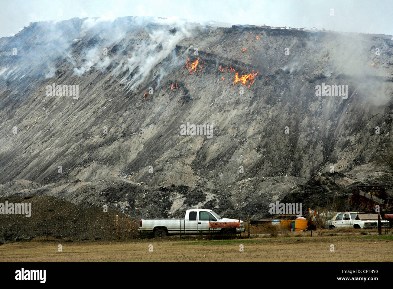 METRO Flames pop in and out of the mulch pile fire in Helotes Wednesday