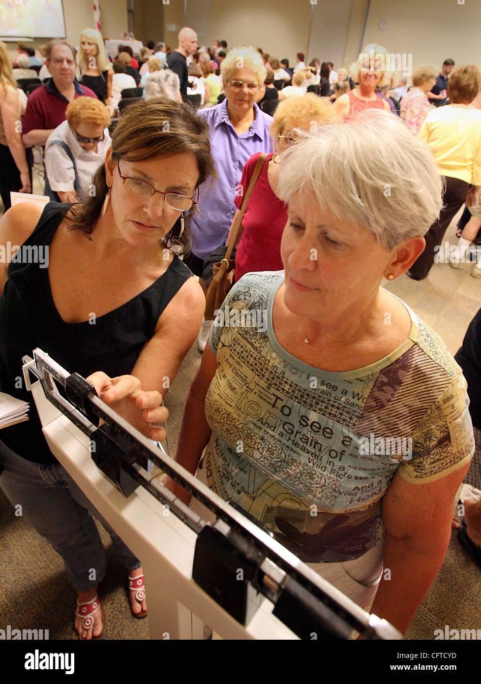 010607 SC met Decision (1of6) Staff photo by Bob Shanley / The Palm Beach Post 0031982A With story by Lona O'Connor----DELRAY BEACH----(left)  C.R. Newman helps Andrea Goldstein of Delray Beach weight-in at the start of the Delray Decision kickoff at the Delray Beach Public Library, Saturday. Severa Stock Photo