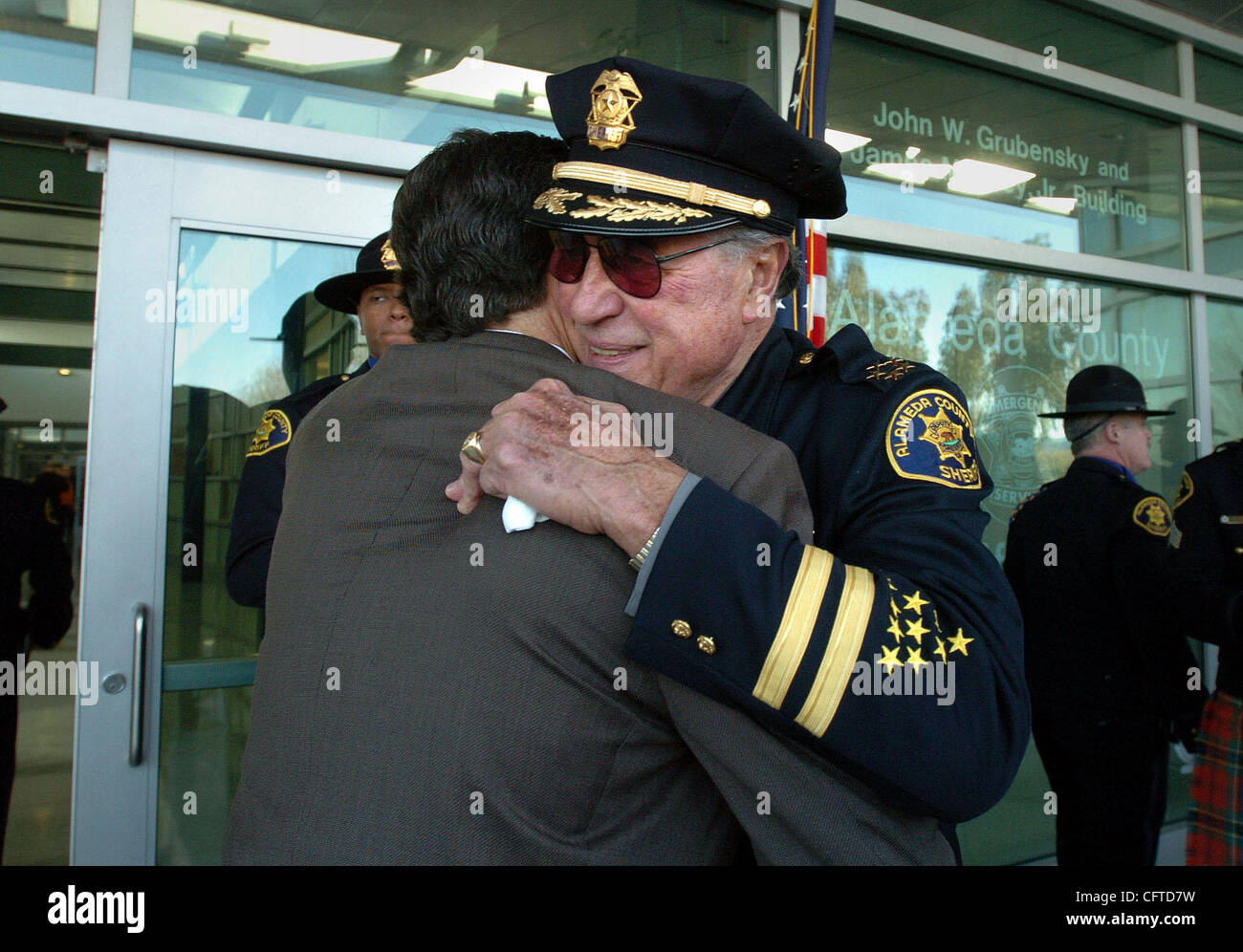 Sheriff Charles Plummer hugs a well-wisher following a ceremony ...