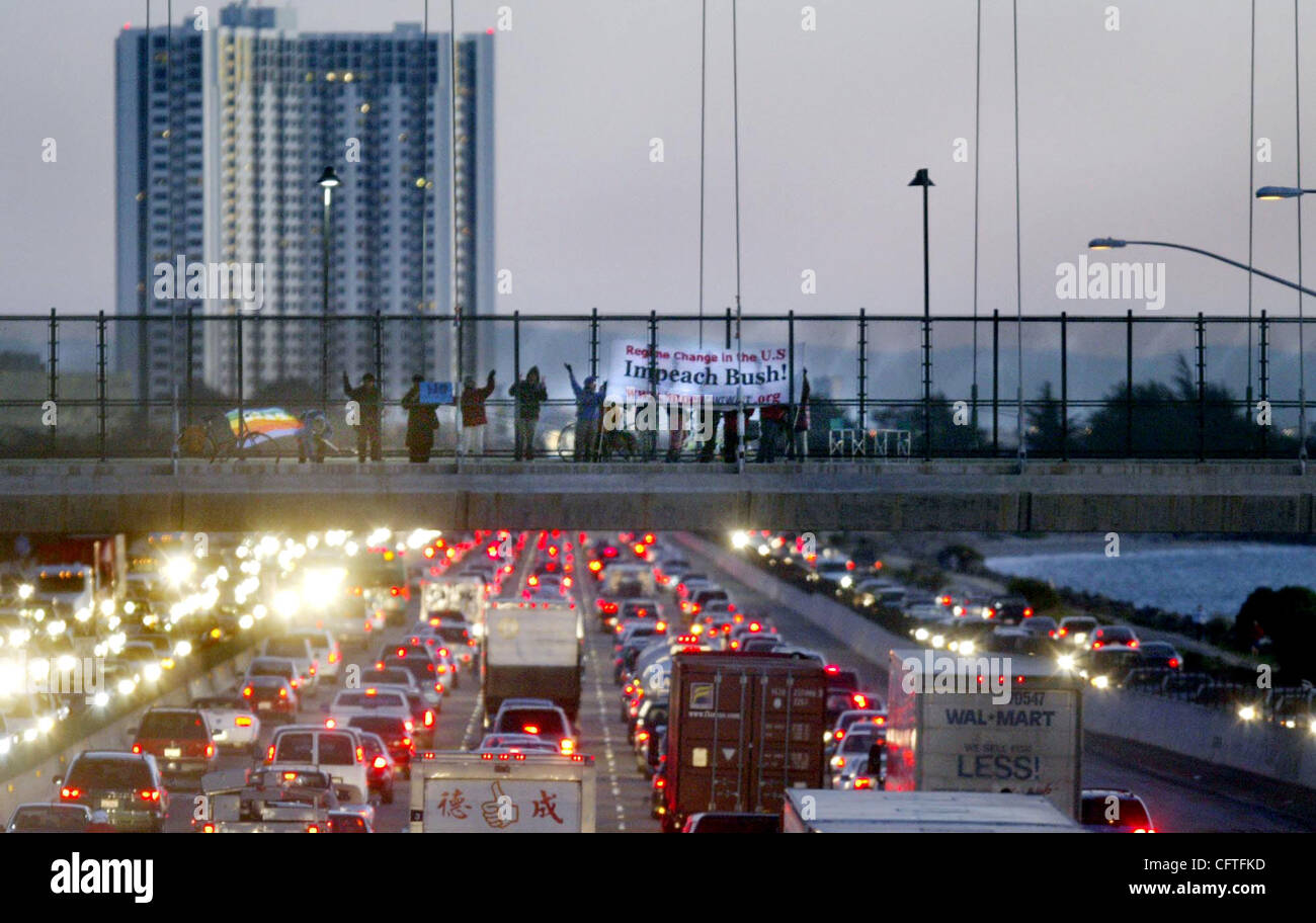 Demonstrators hold antiwar signs on the overpass on I-80 in Berkeley ...