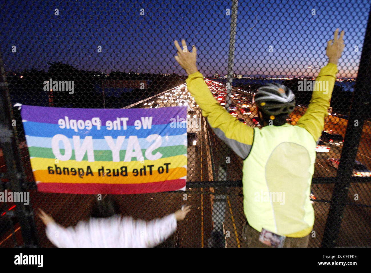 Daniel Hernandez, right, and Alejandra Covarrubias, 8,  of Oakland and Richmond respectively, wave to the motorists as part of the antiwar protest on the overpass on I-80 in Berkeley, California on Thursday, Jan. 11, 2007.  They protest against President George W. Bush's plan to send more U.S. troop Stock Photo