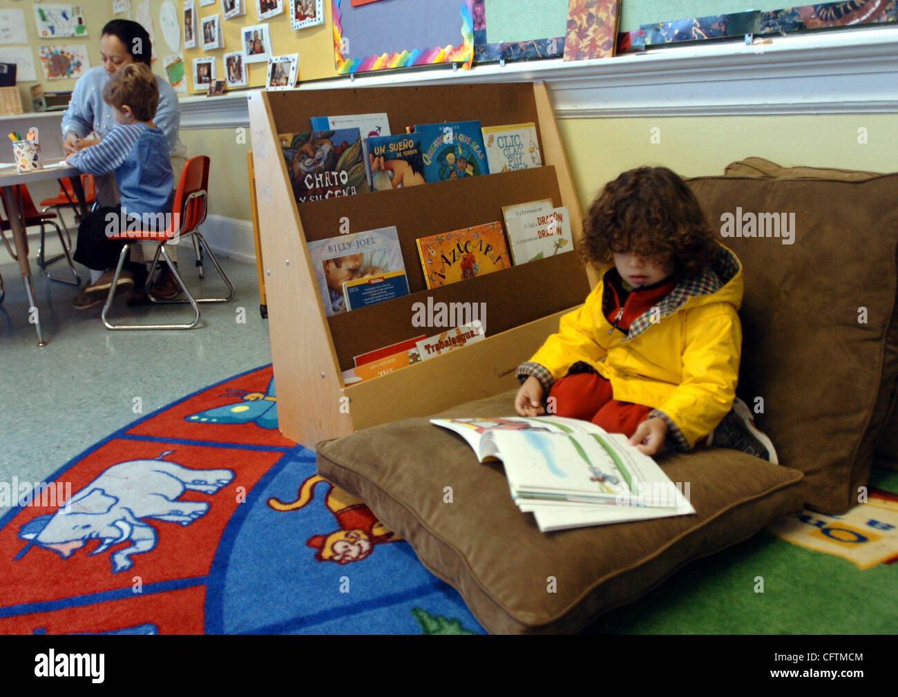 Santiago Cuba looks through the book, 'Jorge el Curioso,' or 'Curious George,' in a pre-primary class at Escuela Bilingue Internacional Spanish language immersion school in Oakland, Calif., on Wednesday, Jan. 17, 2007. (Contra Costa Times/Mark DuFrene) Stock Photo