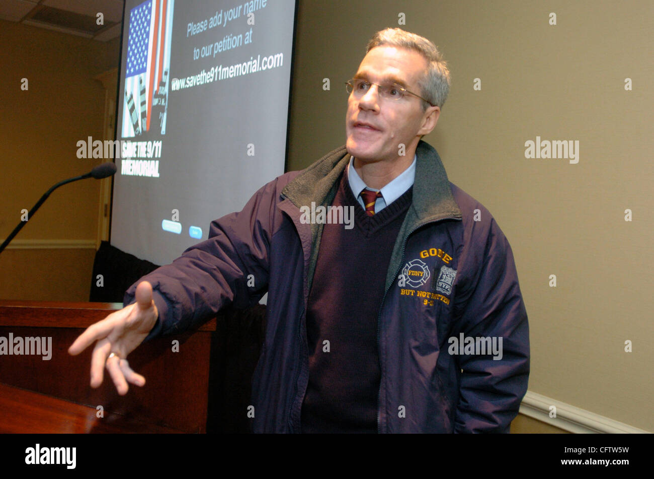 Michael Burke, of the Bronx, holding a picture of his brother, FDNY