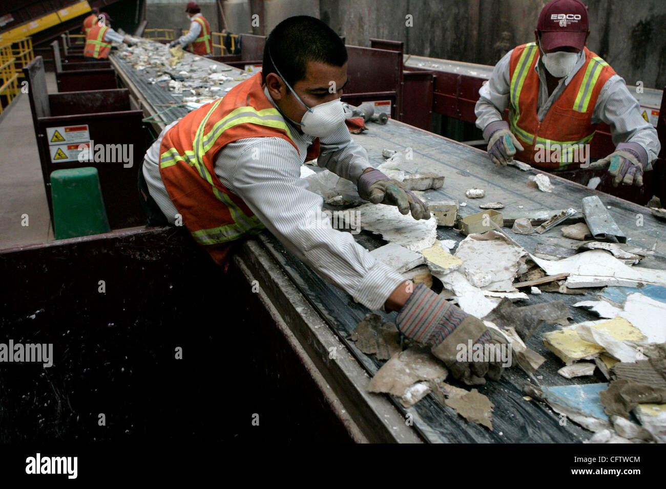 January 24, 2006 Lemon Grove, CA JAVIER RODRIGUEZ, left, and GERONIMO  ESPINOZA, right, pull drywall off a conveyor belt containing mixed  construction and demolition materials at EDCO recycling facility in Lemon  Grove.