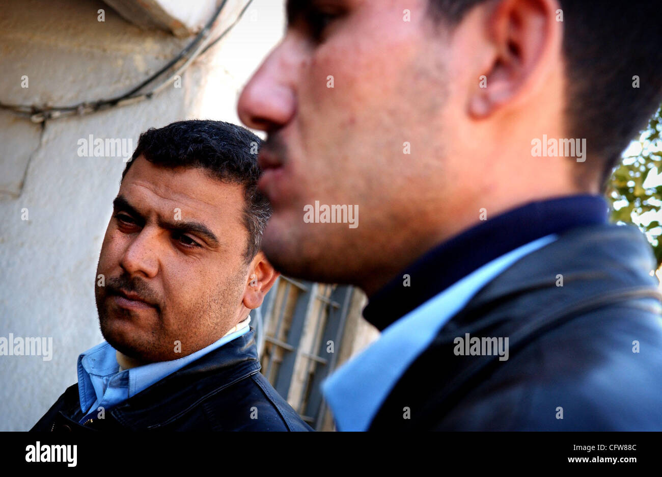 Feb 11, 2007 - Siniyah, Salah ad Din, Iraq - Police Lt. Mastafa Khalad, left, and police Lt. Ali Mohammed Hamed talk about how the violence has subsided in Siniyah, Iraq, since the military locked down the entire town in November 2005. (Credit Image: © Andrew Craft/The Fayetteville Observer/ZUMA Pre Stock Photo