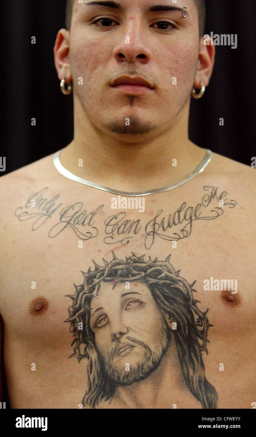 FOR METRO - George Perez, 20, shows off a tattoo on his chest with a image  of jesus and the words 