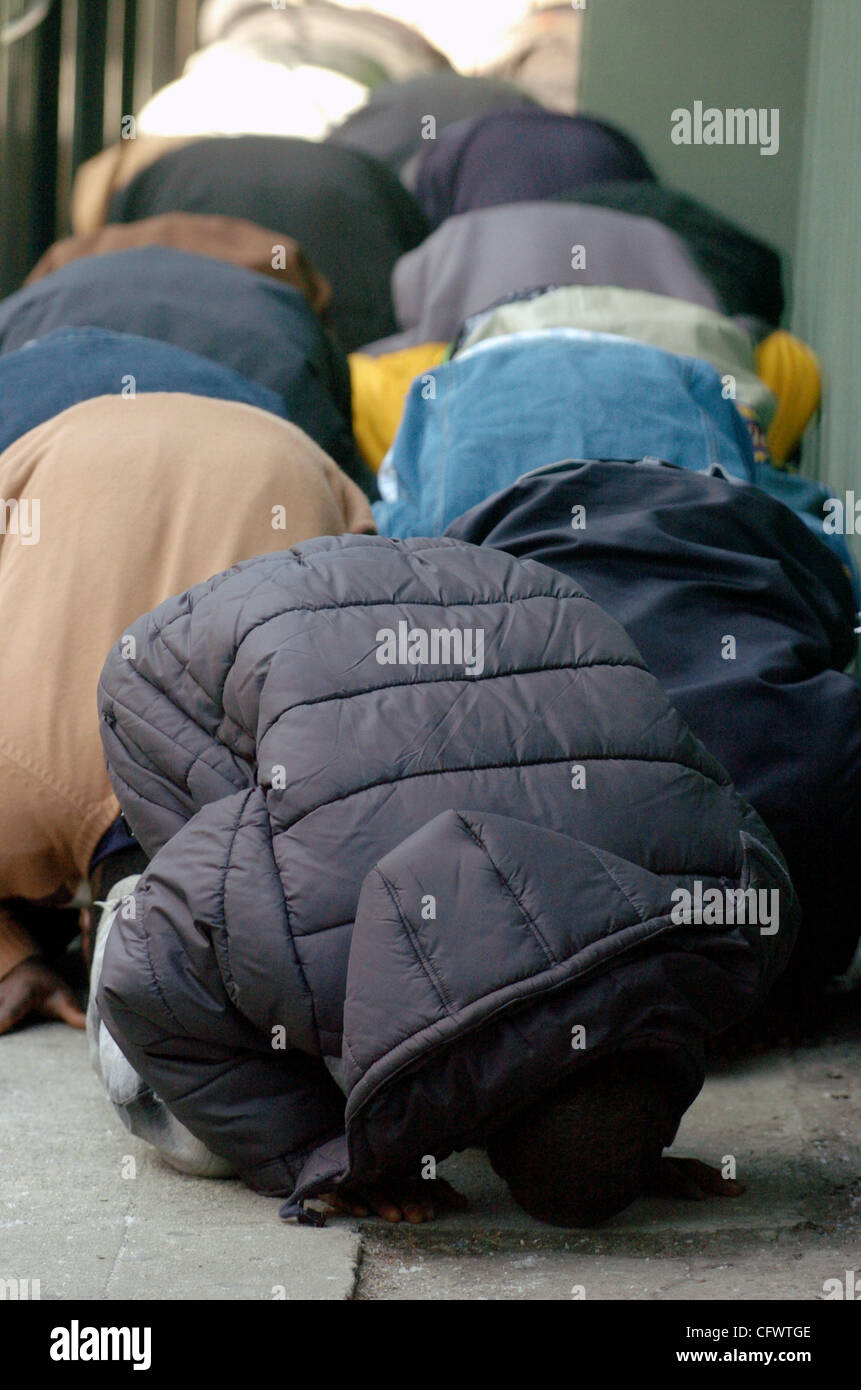 With the mosque filled to capacity people pray in a fenced in area
