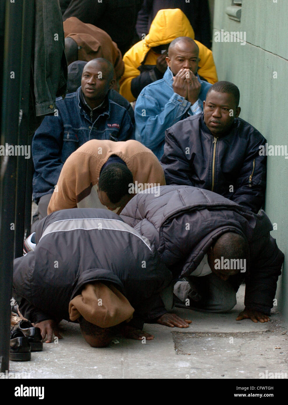 With the mosque filled to capacity people pray in a fenced in area