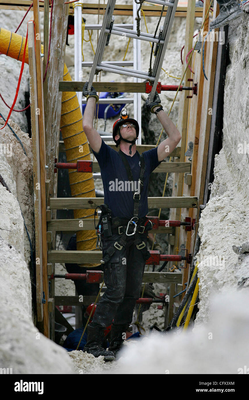 METRO - A rescue worker hoists a ladder out of a trench where Lawrence Martinez was trapped Wednesday, March 21, 2007 at a worksite near Castle Hills. The rescuers had to stabilize the dirt around Martinez before freeing him. BAHRAM MARK SOBHANI/STAFF Stock Photo