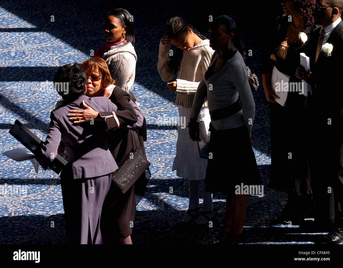 (I to r) Isabel Emerson gives her condolences to Etta Harris, wife of ...