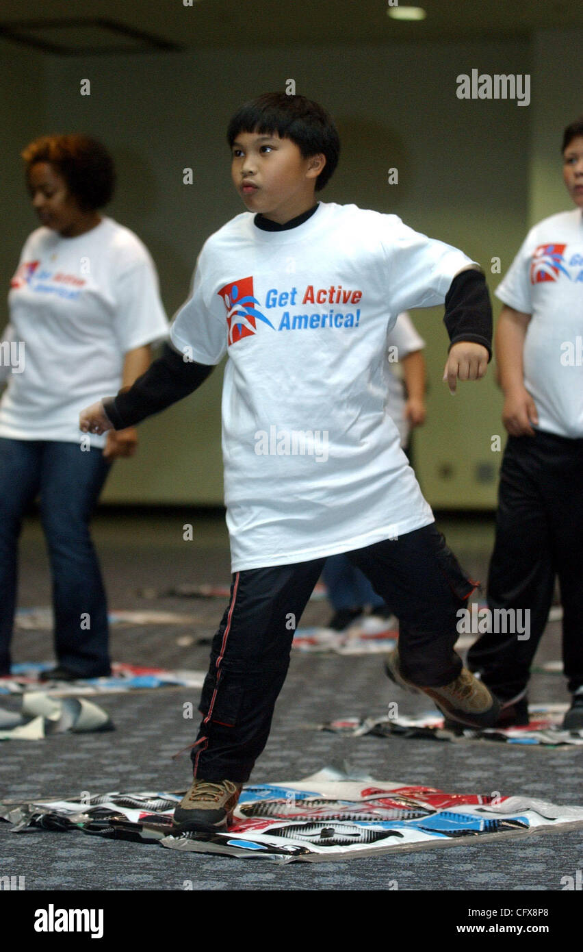 Fourth-grade student Neil Bamba, 9, joins classmates from Cesar Chavez School in San Francisco at the International Health, Raquet and Sportclub Association convention in San Francisco, Calif., on Wednesday, March 28, 2007. Dance mats made by Konami were set out for students to use during the Dance, Stock Photo