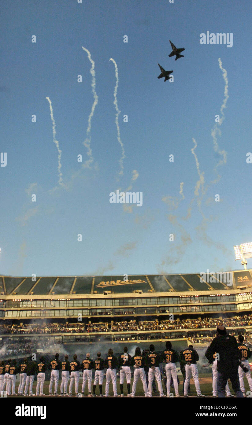 Oakland A's players lineup while two jets fly by before the start of the team's first home game in Oakland, Calif. on Monday April 9, 2007.   (Nader Khouri/Contra Costa Times) Stock Photo