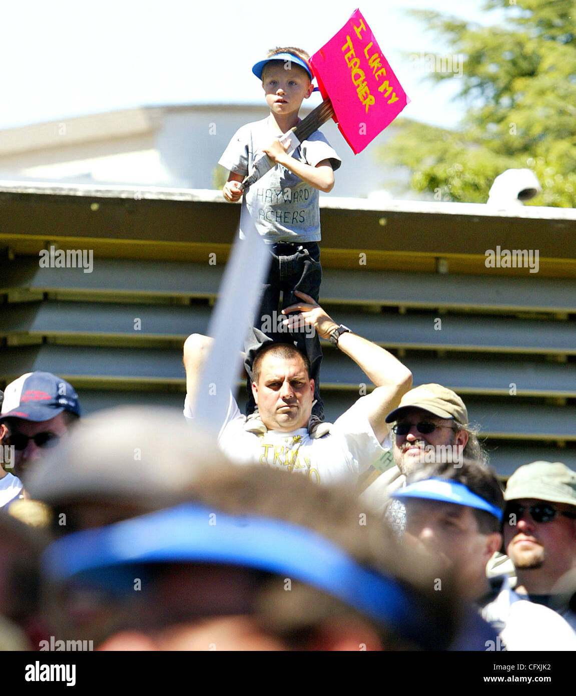 Hayward student Jet Spencer ,7, gets a better view from his father Robert's shoulders during a rally of teachers and their supporters at the Hayward Unified School District offices on Amador St. during a rally on Monday April 16, 2007 in Hayward, California. (Aric Crabb /The Oakland Tribune) (Aric C Stock Photo