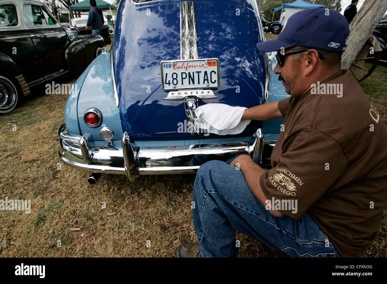April 21, 2007, San Diego, USA. JAIME GUEVARA polishes his 1948 Pontiac Streamliner at Chicano Park. He and other  members of his carclub, the Coachmen, made camp at the back of the park, admiring everyone's cars, making carne asada and ceviche. Saturday was the 37th annual  Chicano Park Day. Hundre Stock Photo
