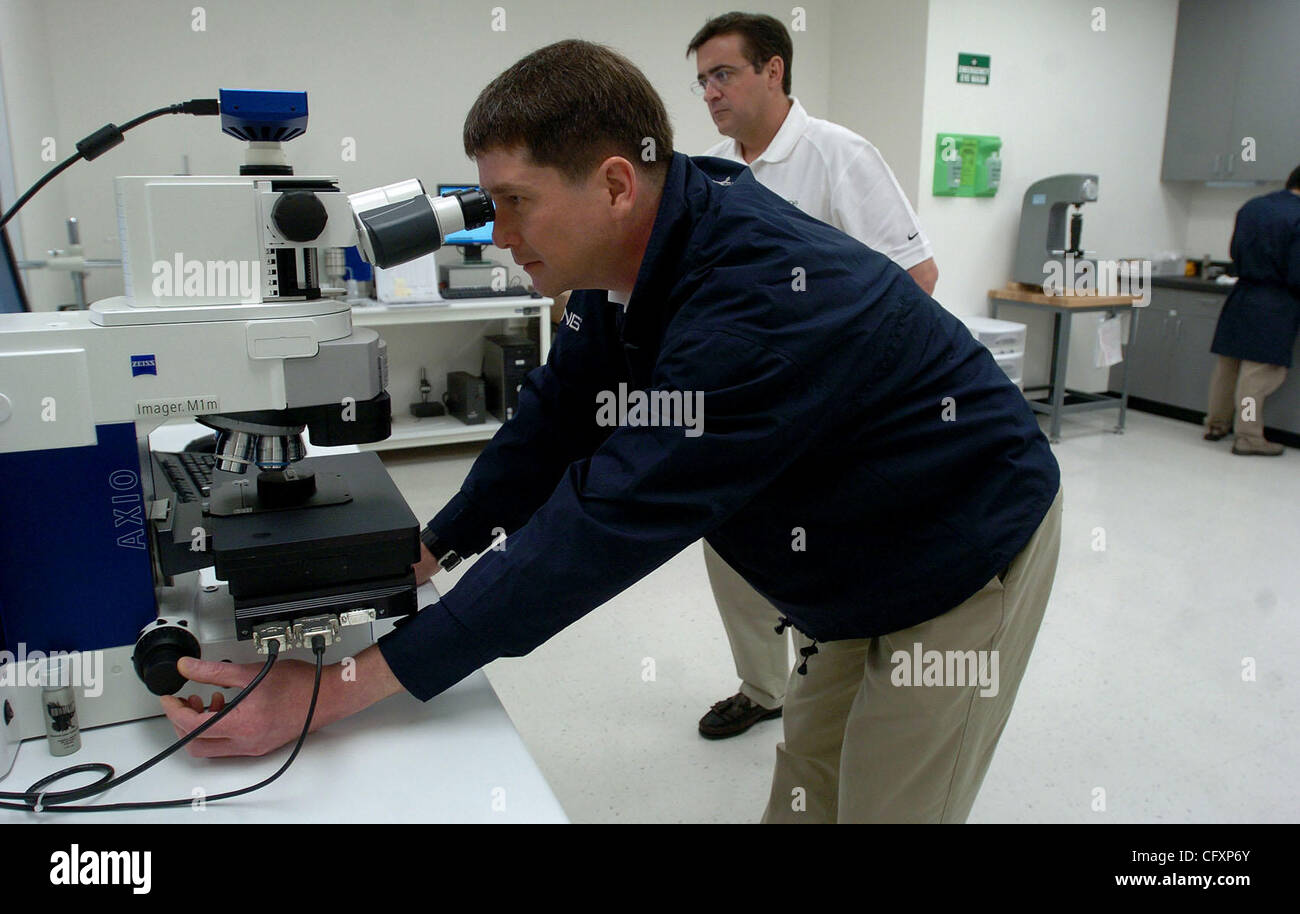 Analytical lab manager Miguel Oppus examines some coating under a