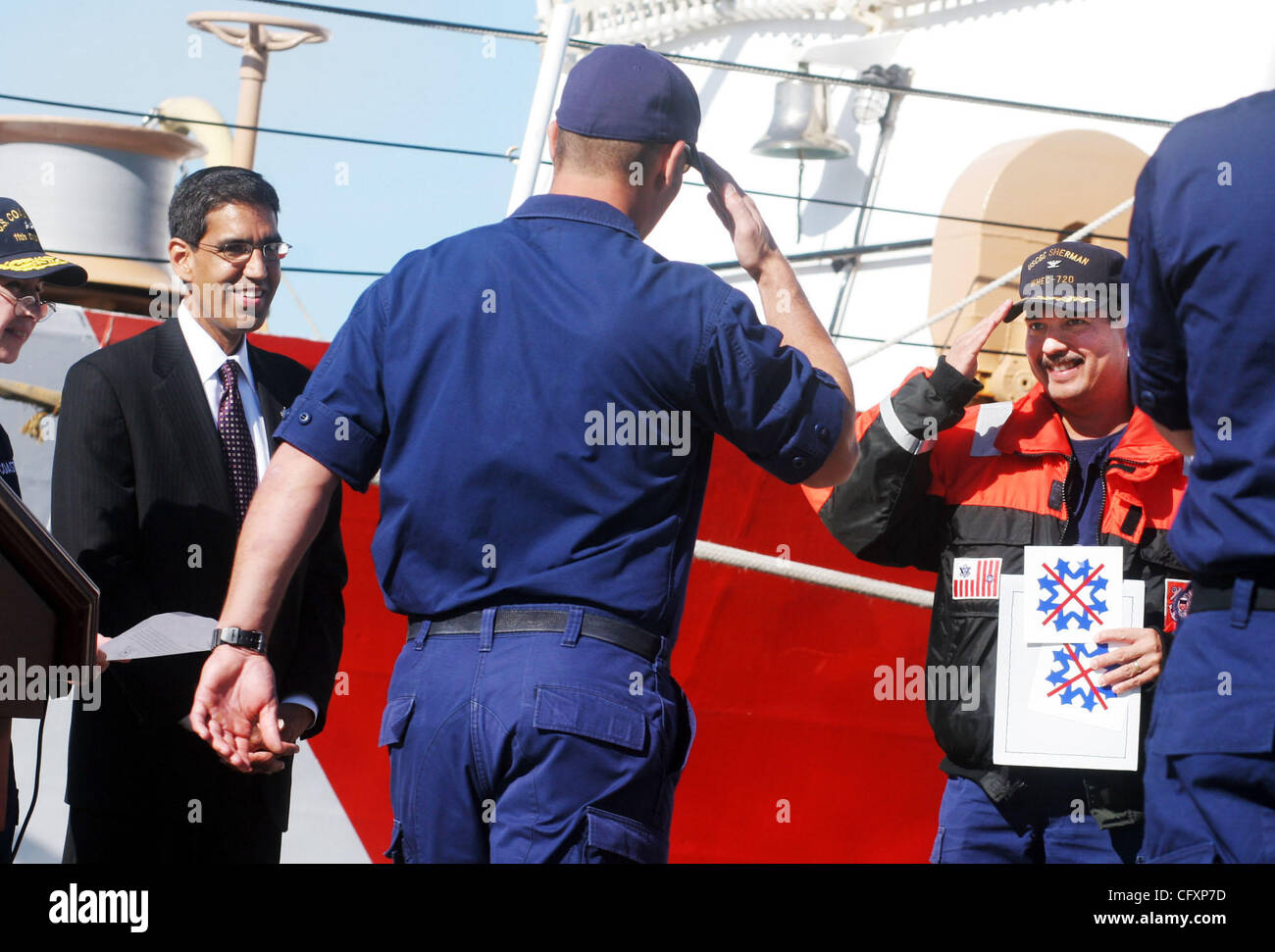 Apr 23, 2007 - Coast Guard Island, CA, USA - Commanding officer of the Coast Guard cutter Sherman, CHARLIE DIAZ, salutes to a another officer as Uttam Dhillon, Dirstor of Counter-Narcotics Enforcement looks on during a press conference on Coast Guard Island in Alameda, CA. April 23, 2007 announcing  Stock Photo